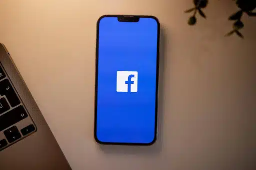 Smartphone displaying Facebook app symbolizing effective Facebook marketing techniques for orthodontists