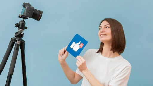 Content creator filming video showing how to do Facebook marketing for engagement