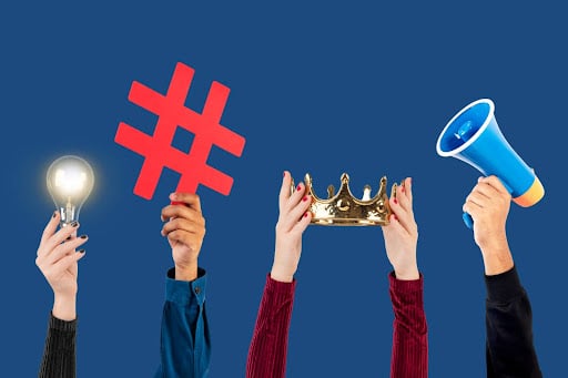 Hands holding hashtag symbol, crown, light bulb, and megaphone illustrating X marketing mistakes in dental social media strategy