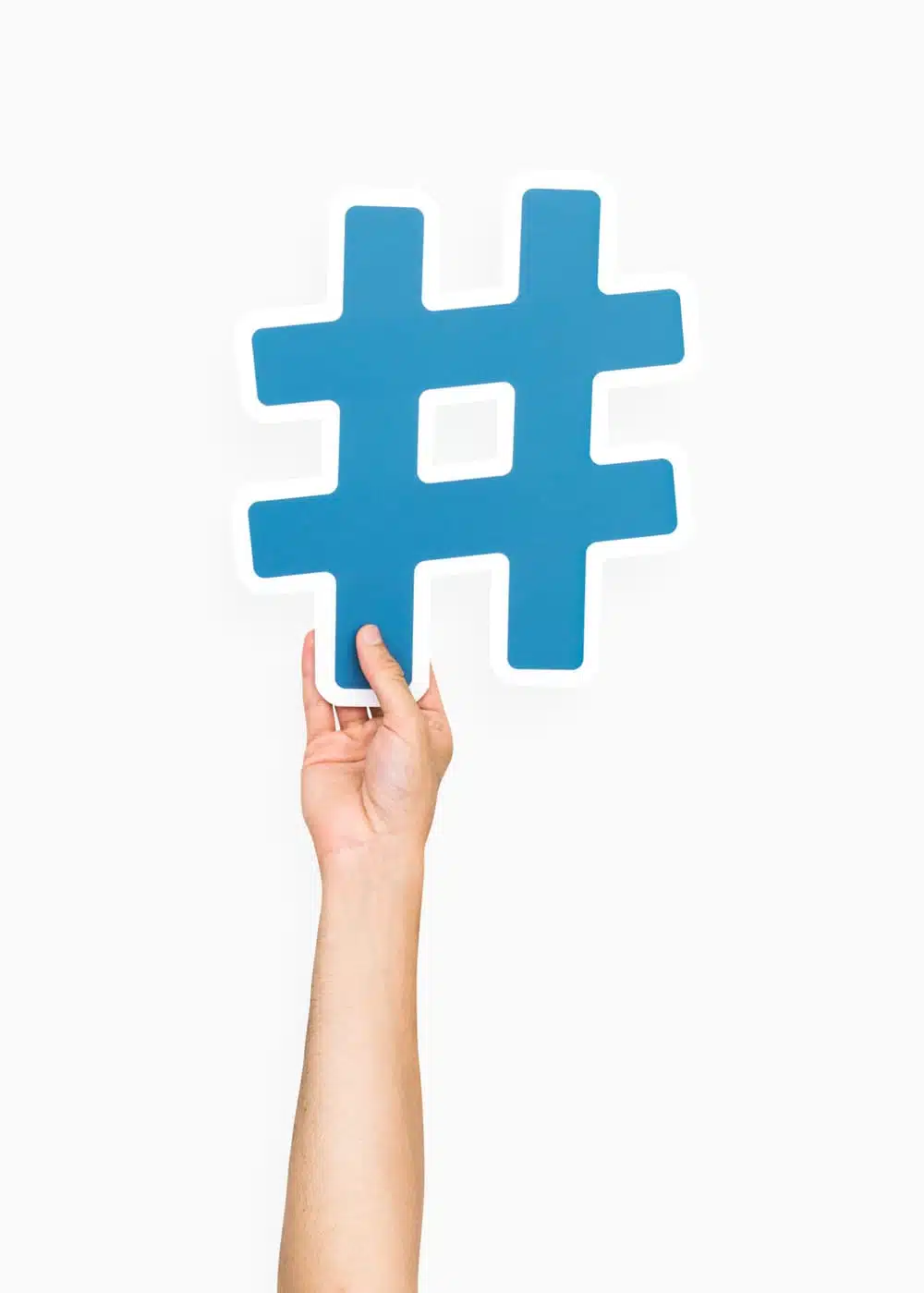 Hand holding large blue hashtag icon illustrating hashtag holidays for social media campaigns