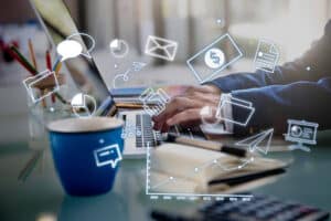 Professional using laptop with digital icons representing orthodontic marketing strategies and online practice growth