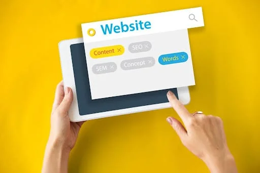 Tablet screen showing website content and keywords related to the type of seo services