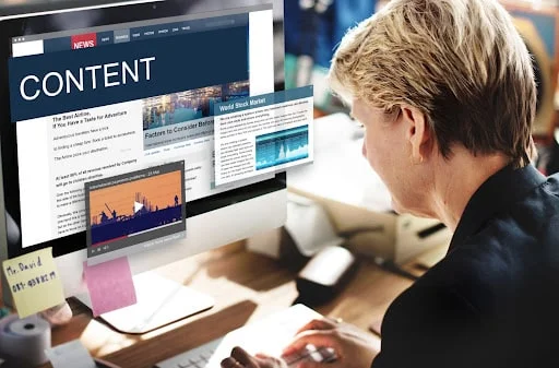 Marketer reviewing online content on a screen representing content marketing strategy and SEO